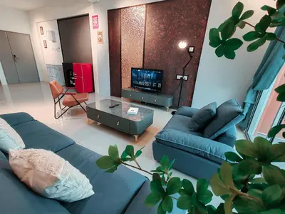 a living room with a blue couch and a tv at INS Pavillion by irainbow in Ipoh