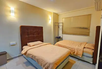 a bedroom with two beds and a window at Laguna 1, Marina Island by TZ Homestay in Lumut