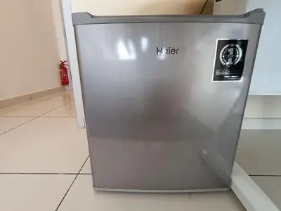 a metal refrigerator sitting on the floor in a room at The Horizon Ipoh Dual L13 by Grab A Stay in Ipoh