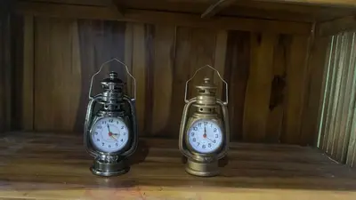 two clocks sitting next to each other in a room at Homestay Fida in Gerik