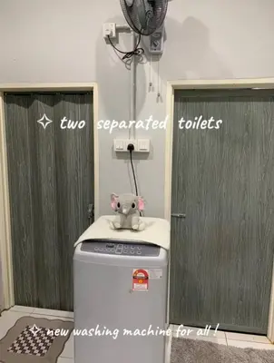 a teddy bear sitting on top of a washing machine at Homestay Fida in Gerik