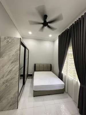 a bedroom with a bed and a ceiling fan at D’Asam Homestay Baling in Baling