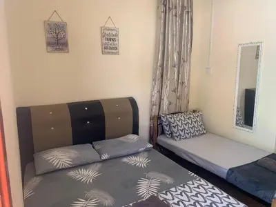 a room with a bed and a couch and a mirror at Chalet Naqib in Gerik