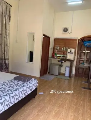 a bedroom with a bed and a desk in a room at Chalet Naqib in Gerik