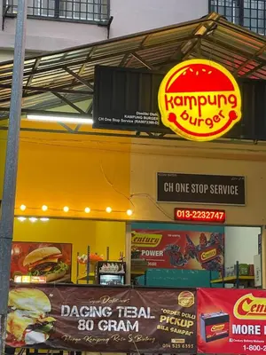 a restaurant with signs on the side of a building at ROYAL LILY TANAH RATA BY JUNIKASTAY in Tanah Rata