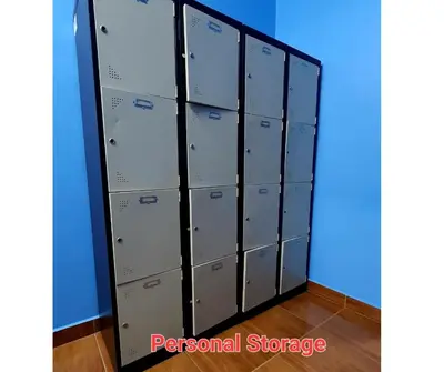 a row of lockers in a room with a blue wall at ShopLot Hostel Pangkor in Pasir Bogak