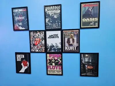a collage of movie posters on a blue wall at ShopLot Hostel Pangkor in Pasir Bogak