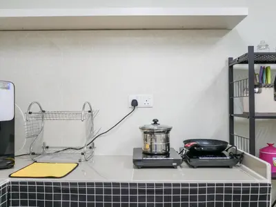 a kitchen counter with a stove with a pot on it at Cheerful Guesthouse #Adventist#BudgetStay in George Town