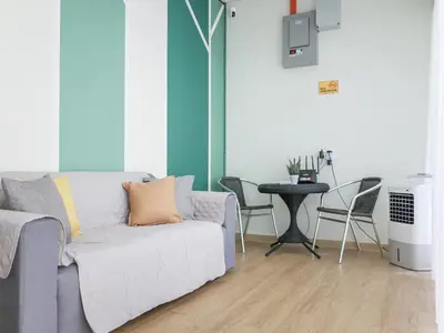 a living room with a couch and a table with chairs at Cheerful Guesthouse #Adventist#BudgetStay in George Town