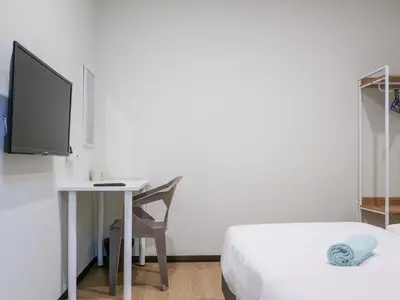 a bedroom with a desk with a computer and a bed at Cheerful Guesthouse #Adventist#BudgetStay in George Town