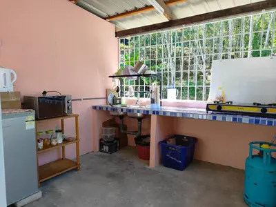 a kitchen with a blue counter and a window at Homestay Teratak D`kemangi with Private Pool in Baling