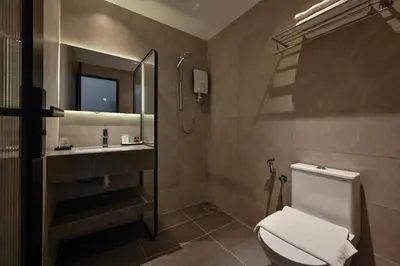 a bathroom with a toilet and a sink and a mirror at Macalister 288 in George Town
