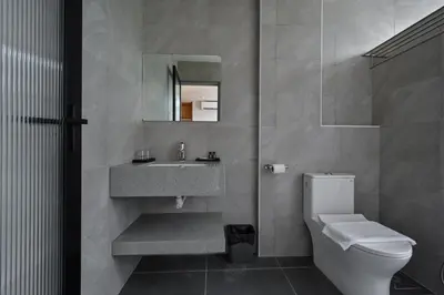 a bathroom with a sink and a toilet and a mirror at Macalister 288 in George Town