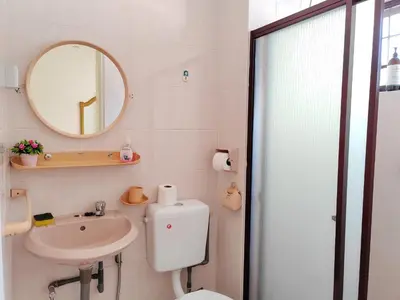 a bathroom with a toilet and a sink and a mirror at Ipoh Station 18 Homestay in Ipoh