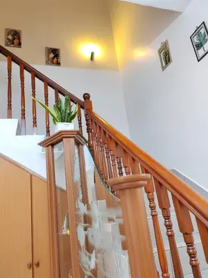 a wooden staircase with a potted plant on it at Ipoh Station 18 Homestay in Ipoh