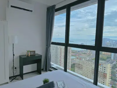 a bedroom with a bed and a large window at DD Condominium 2Bedroom Sea view Georgetown Penang in Jelutong