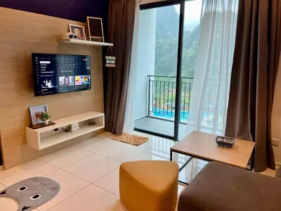 a living room with a tv and a large window at Hotspring 2 Room Suite @ Sunway Onsen with Theme Park View 4 to 6 pax in Tambun