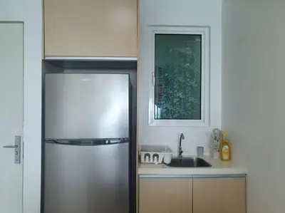 a kitchen with a stainless steel refrigerator and a sink at Southbay Seaview Condo A16 #10minQueensbay #15minSPICE in Bayan Lepas