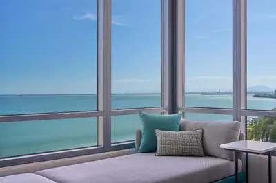 a couch in a room with large windows at Penang Marriott Hotel in George Town