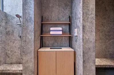a bathroom with a shower with a towel on a shelf at Penang Marriott Hotel in George Town
