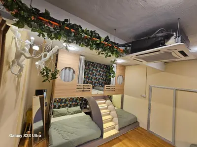 a room with two bunk beds in a tiny house at Lumina Stay @ Kampar 16 pax in Kampar