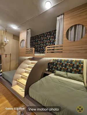 a bedroom with two beds and a mirror at Lumina Stay @ Kampar 16 pax in Kampar