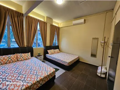 a hotel room with two beds and a window at Lumina Stay @ Kampar 16 pax in Kampar