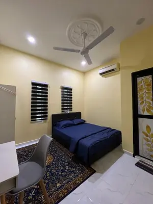a bedroom with a bed and a ceiling fan at Homestay Desa D Junjung Islam Guest Only in Simpang Ampat