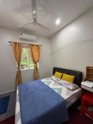 a bedroom with a bed and a window at Homestay Desa D Junjung Islam Guest Only in Simpang Ampat