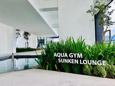 a swimming pool in a building with a sign that reads ayoya gym summer lounge at New 2BR or 3BR Homey Getaway stay 7 to 10 pax at Urban Suites, Georgetown by URBAN STAYCATION LOD COSY in Jelutong