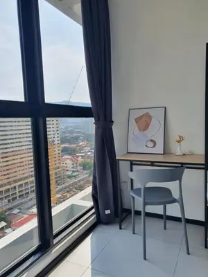 a desk and chair in a room with a large window at Urban Suite Spacious 2 or 3 Bedroom and 2Bathroom at Georgetown by URBAN STAYCATION HENG COSY in Jelutong