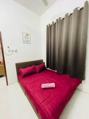 a red bed with a black curtain in a room at Tok Mak Homestay Bukit Mertajam in Kubang Semang
