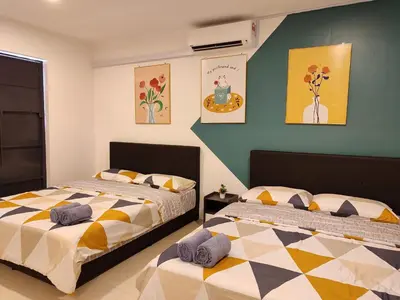 two beds sitting next to each other in a bedroom at Golden 78 Ipoh Homestay in Ipoh