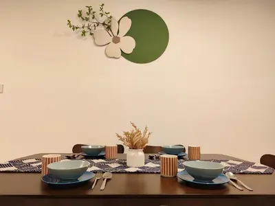 a table with bowls and plates on top of it at Golden 78 Ipoh Homestay in Ipoh