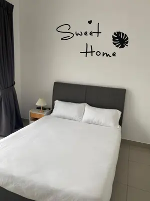 a bedroom with a bed and a sign that reads sweet home at Cloud Nine Homestay in Taiping