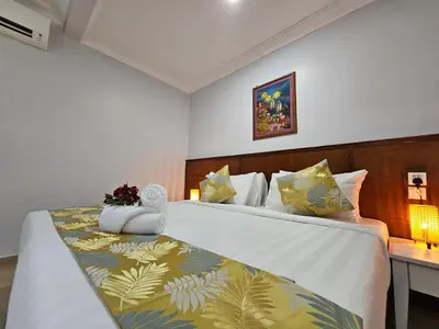 a hotel room with a bed and a desk at Cottage Inn Gerik in Gerik