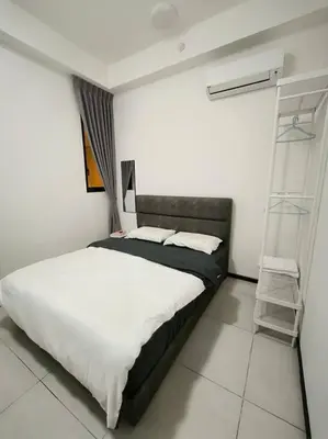 a bedroom with a large bed and a ladder at Urban Suites, Best Seaview and Cityview in Town in Jelutong