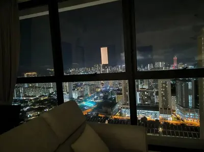 a view of a city at night from a window at Urban Suites, Best Seaview and Cityview in Town in Jelutong