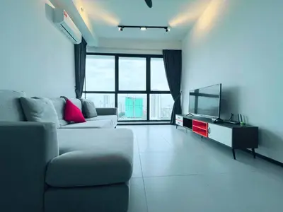 a living room with a couch and a flat screen tv at Urban Suite by Uptrend Home Management in Jelutong