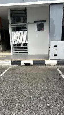 a white building with a window on the side of a street at SohoMimi Seri Iskandar in Kampung Bota Kiri