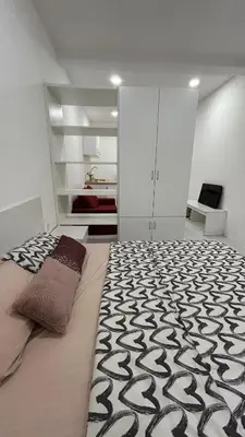 a bedroom with a bed with a black and white rug at SohoMimi Seri Iskandar in Kampung Bota Kiri