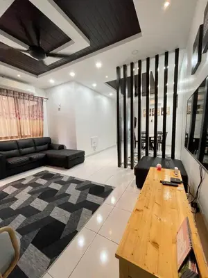 a living room with a couch and a table at Thetamu Homestay مسلم Kepala Batas in Kepala Batas