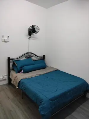 a bedroom with a bed with blue pillows at AZK HOMESTAY in Sungai Besar