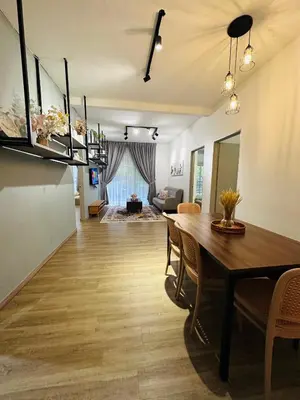 a dining room and living room with a table and chairs at Adamhawa Homestay Emerald Avenue Brinchang in Brinchang