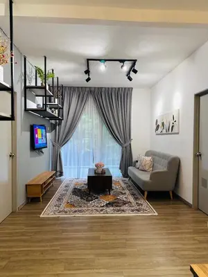 a living room with a couch and a tv at Adamhawa Homestay Emerald Avenue Brinchang in Brinchang