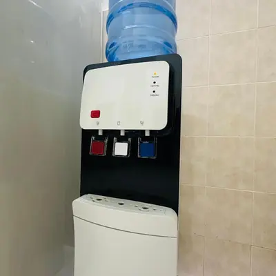 a water dispenser above a toilet in a bathroom at CYC homestay 48 Bercham in Kampong Batu Lapan