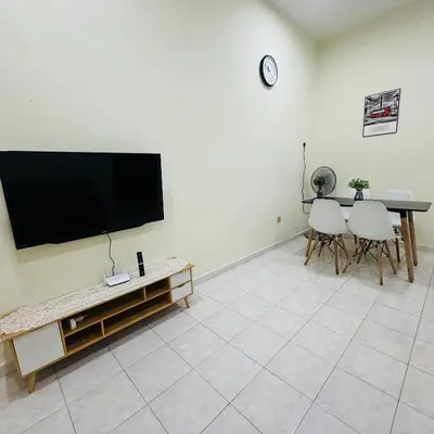 a living room with a flat screen tv on a wall at CYC homestay 48 Bercham in Kampong Batu Lapan