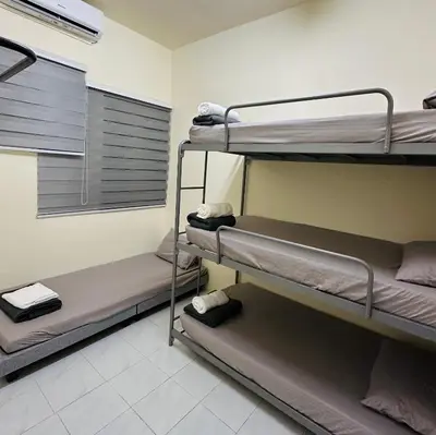 a room with three bunk beds in a hospital at CYC homestay 48 Bercham in Kampong Batu Lapan