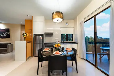 a kitchen and dining room with a table and chairs at SGI Vacation Club Villa @ Damai Laut Holiday Resort in Lumut
