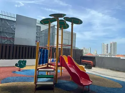 a playground with colorful slides and slidesktop at JazzA 2R3B Suite Strait Quay Near Stonyhurst School by Homey Planet in Tanjong Tokong